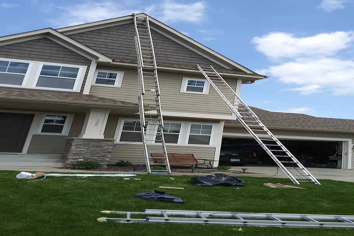 Two story home with gray siding painted